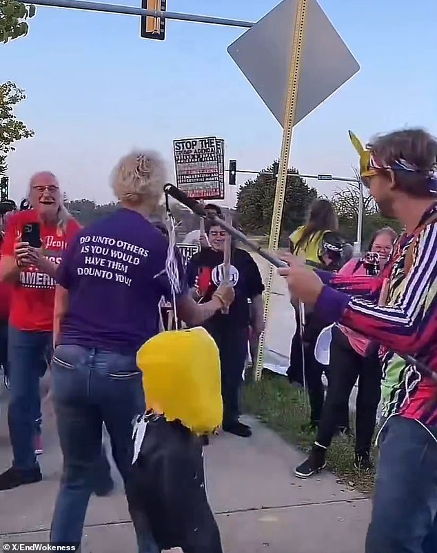 Protester strikes piñata of Trump while wearing 'Make America Kind Again' shirt