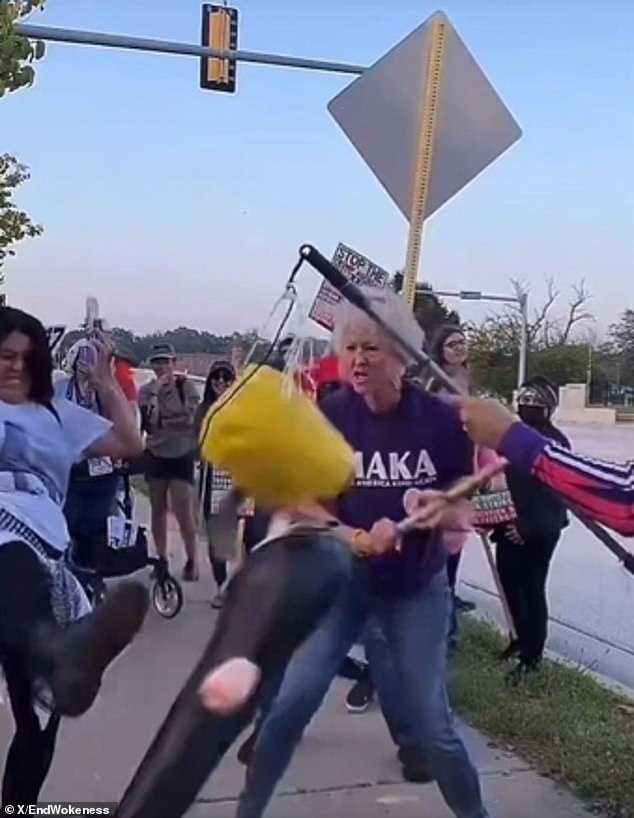Protester strikes piñata of Trump while wearing 'Make America Kind Again' shirt