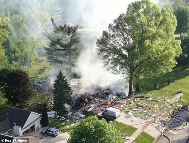 Michigan fire suspected as husband's murder-suicide plot kills him, injures wife.