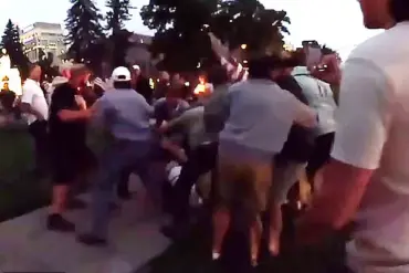 Candlelight Vigil for Charlie Kirk Disrupted by E-Bike Rider's Slur, Leading to Violent Confrontation